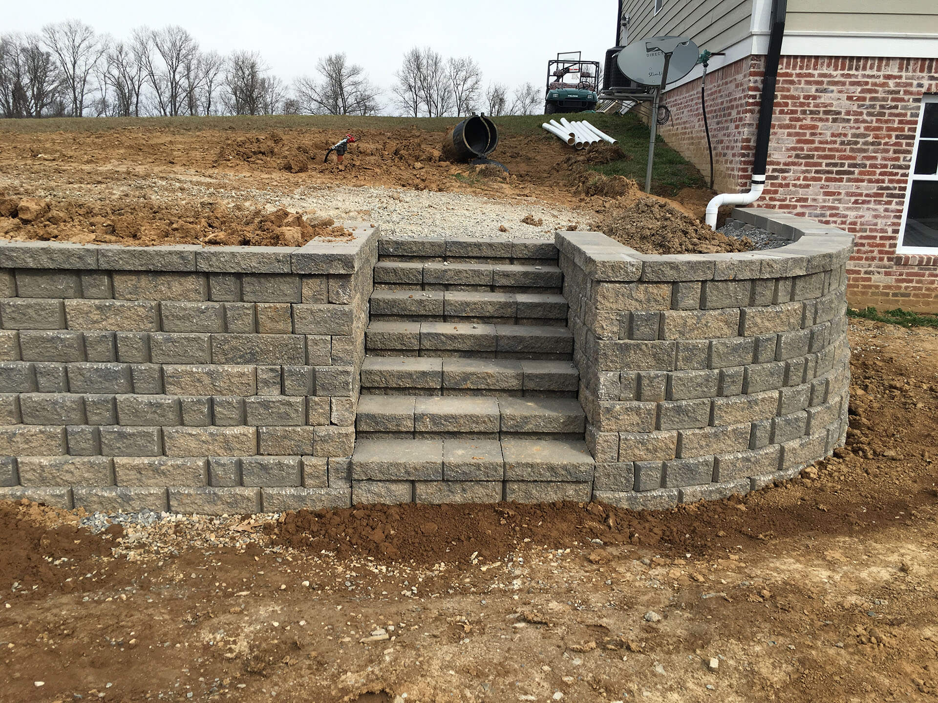 stone retaining wall with integrated stairway landscape Scott City, MO Project