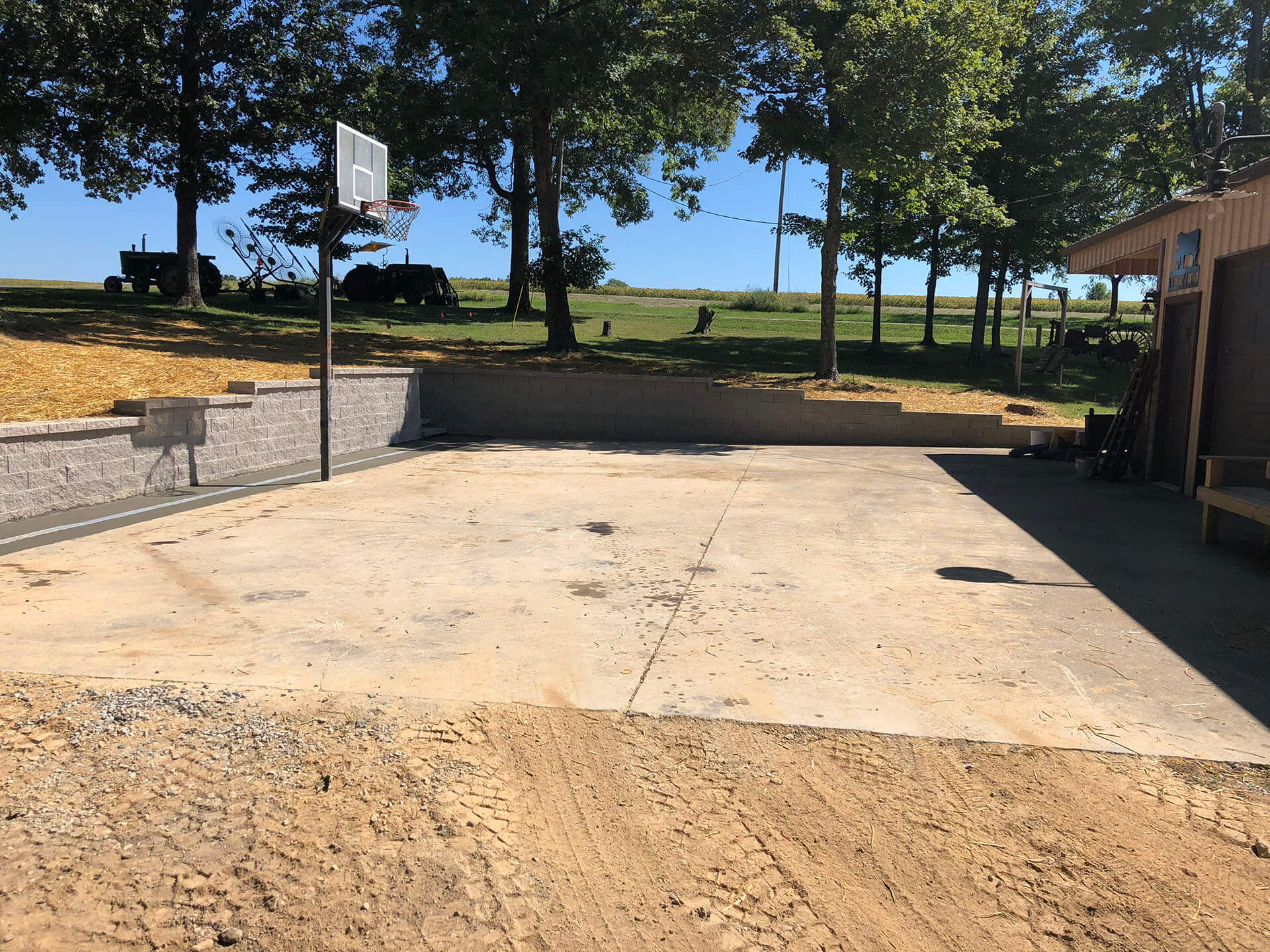 basketball court and integrated stone retaining wall for a home in Leopold, MO Project