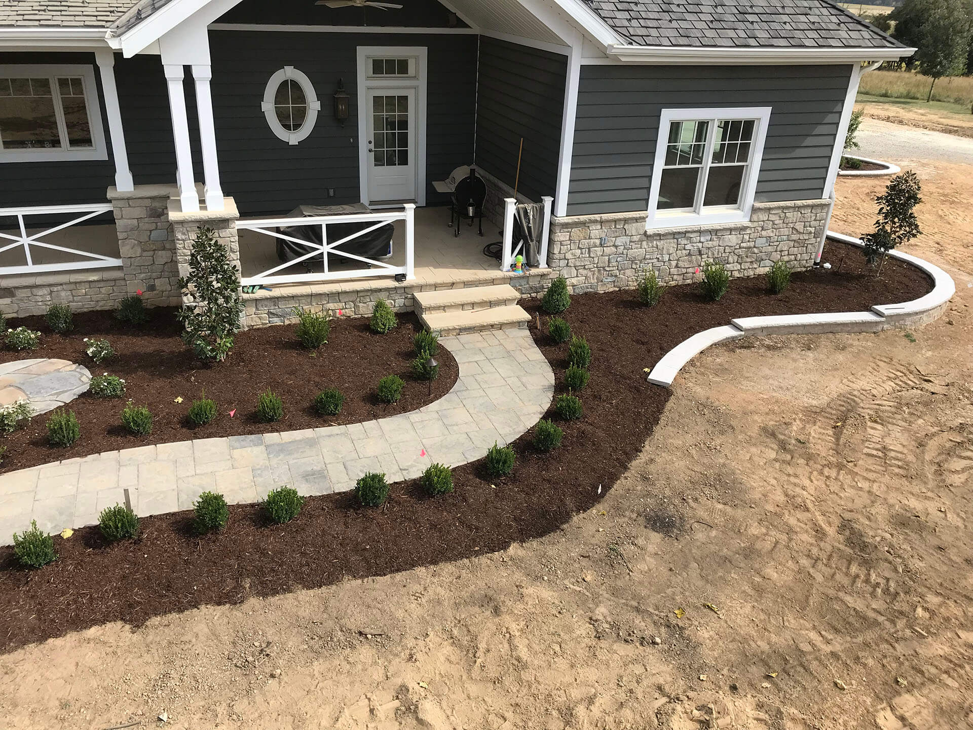 landscaping with boxwoods, plantings with low retaining walls Dexter, MO Project