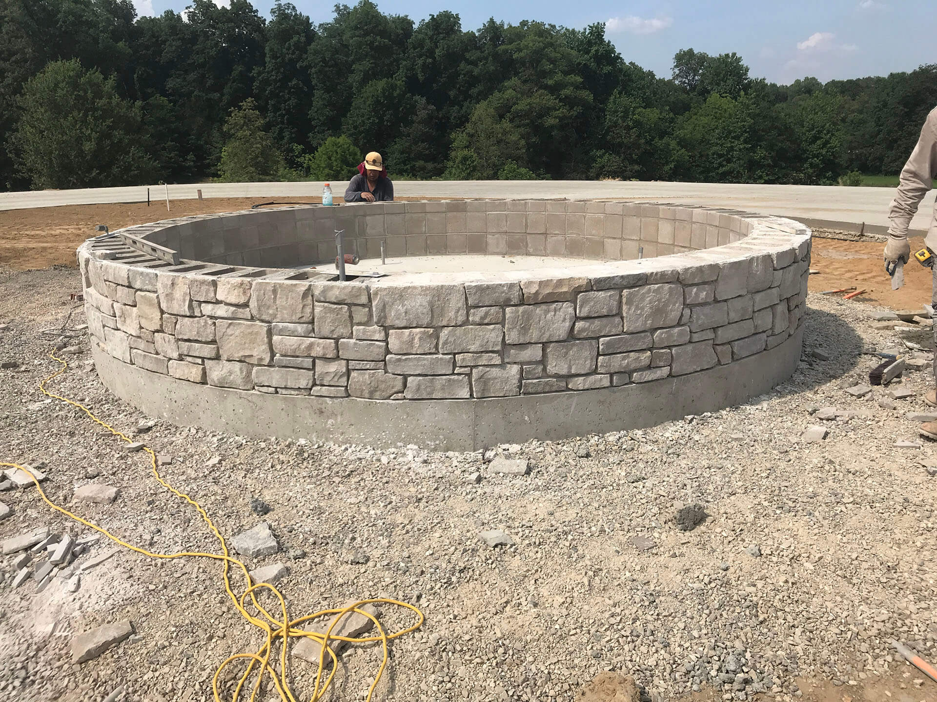 worker assembles a stone fountain Dexter, MO Project