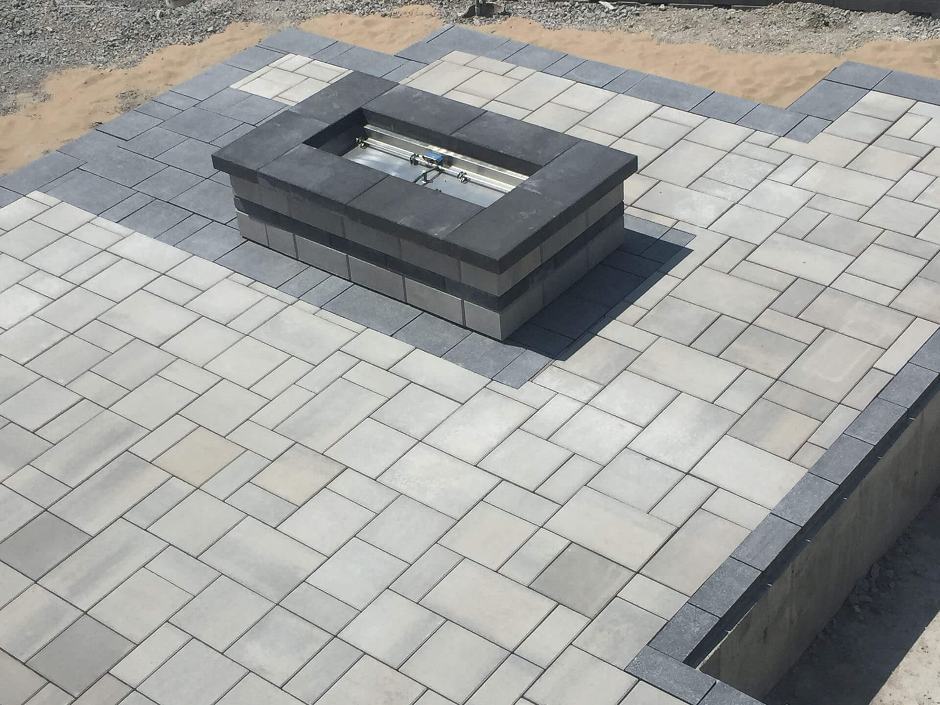 stone fire pit on a gray and white patio Cape Girardeau, MO Project