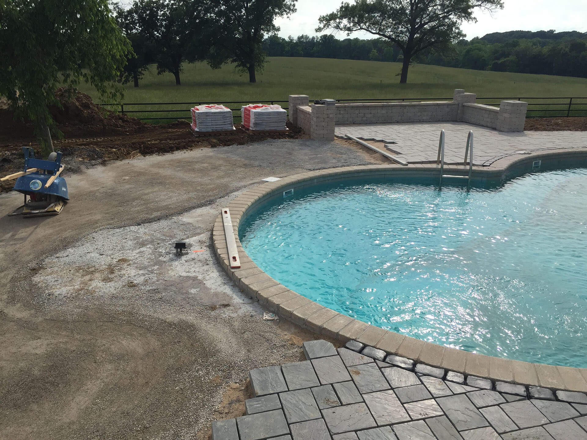placing a natural stone pool deck for a home in Jackson, MO Project