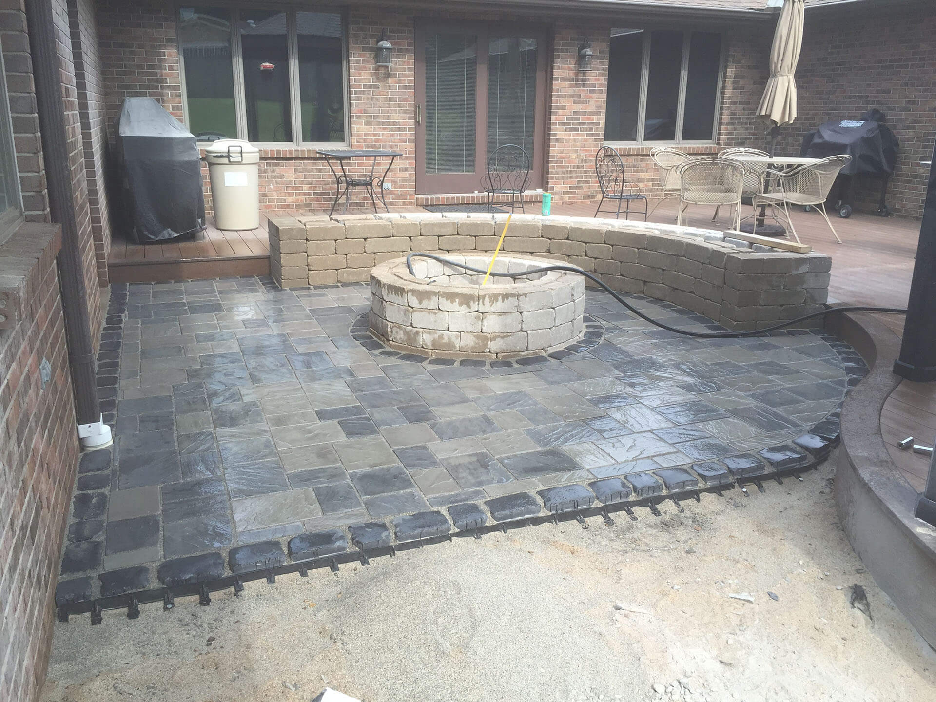 stone fire pit with curved stone bench Cape Girardeau, MO Project